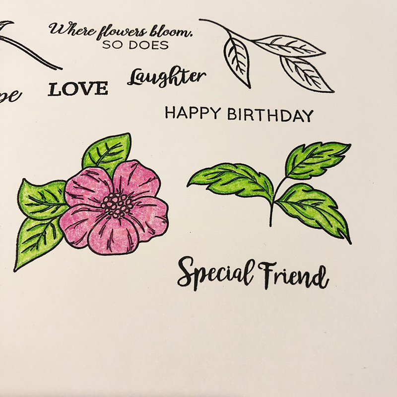 Living Creatively with Fibro | A photo of the stamped flower and leaves images, the flower is shades of pink and the leaves are bright leaf green
