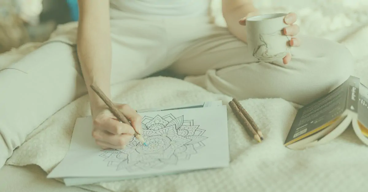 An armchair sat in the middle of the countryside with a lake behind.